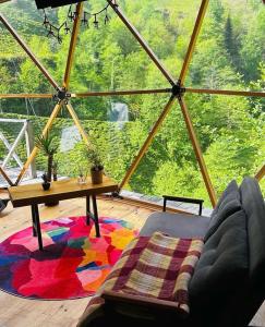 a living room with a table and a rug at North Dome & Suite in Rize