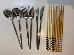 a group of utensils sitting on top of a table at EveryNet Shinjuku by Tranova in Tokyo