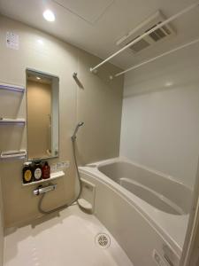 a bathroom with a bath tub and a sink at EveryNet Shinjuku by Tranova in Tokyo +169 photos