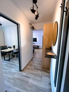 a room with a hallway with a mirror and a table at Central Station Two-Bedroom Family Apartment in Timişoara