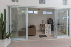 a living room with sliding glass doors and a couch at Tranquil Mediterranean Villa Kerobokan WCS in Kerobokan