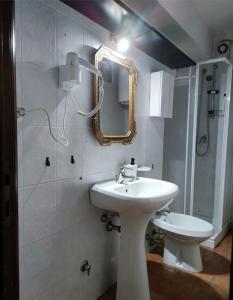 a bathroom with a sink and a mirror on the wall at Appartamento nel cuore di Campo Imperatore in Castel del Monte