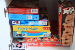 a stack of board games on a shelf at Casa Mariposa - A Foothill Retreat near Yosemite in Mariposa