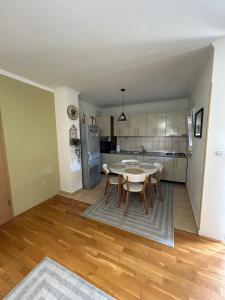 a kitchen and dining room with a table and chairs at Apartman Milla in Ljubuški +9 photos