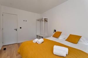a bedroom with two beds with towels on them at Luxe strandappartement met zonneterras & parking in Koksijde