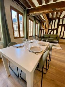 a white table with chairs and wine glasses on it at L’Eucalyptus in Rouen