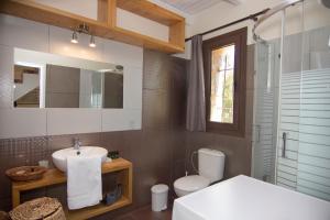 a bathroom with a sink and a toilet at Belles Maisons in Agios Nikolaos