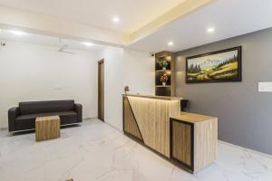 a waiting room with a couch and a reception desk at Super Townhouse 622 Infinity Stays Near Appu Ghar in Gurgaon