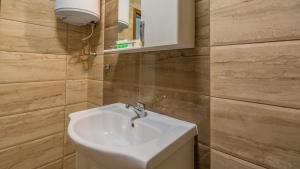 a bathroom with a white sink and a mirror at The old Bakery Apartments in Plovdiv +28 photos