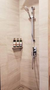 a shower with three bottles on a shelf in a bathroom at Edge Central Pattaya BJ 88 in Pattaya Central