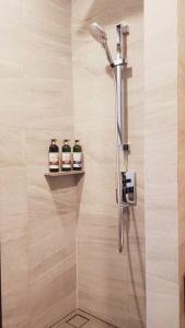 a shower with three bottles on a shelf in a bathroom at Edge Central Pattaya BJ 88 in Pattaya