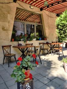 an outdoor patio with tables and chairs and flowers at The old Bakery Apartments in Plovdiv