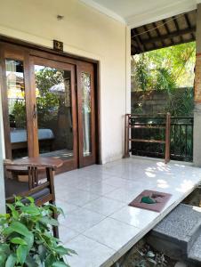 an open door of a house with a patio at Dharma Yoga Homestay dan hostel in Amed