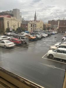 a parking lot full of cars in a city at Star Bar Cafe & Hotel in Launceston