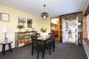 a dining room with a table and chairs at Azidene House & Spa Apartment in Daylesford +24 photos