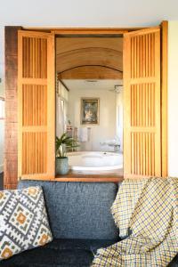 a living room with a couch and a tub at Azidene House & Spa Apartment in Daylesford