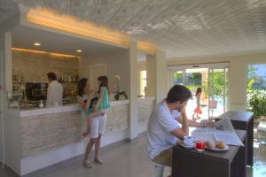 a group of people standing in a restaurant at Hotel Casella in Pietra Ligure