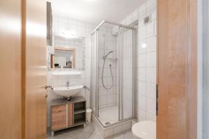 a bathroom with a shower and a sink at Haus Aventurin in Fiss