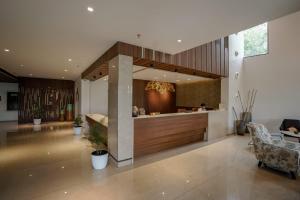 a lobby with a bar in a house at Woodbine Foliage in Malappuram