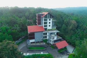 an overhead view of a building with a red roof at Woodbine Foliage in Malappuram