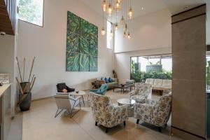 a living room with chairs and a table at Woodbine Foliage in Malappuram