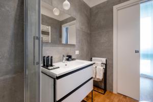 a bathroom with a white sink and a mirror at SWEET LIFE 2 LUXURY and DESIGN APARTMENT in Bari
