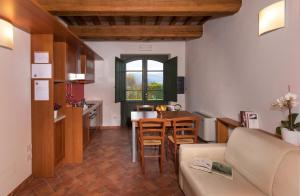 a kitchen and living room with a couch and a table at Coldimolino Resort in Gubbio
