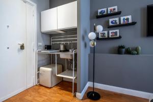 a kitchen with a sink and a desk in a room at SWEET LIFE 2 LUXURY and DESIGN APARTMENT in Bari