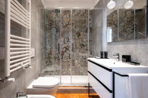 a bathroom with a shower and a toilet and a sink at SWEET LIFE 2 LUXURY and DESIGN APARTMENT in Bari +12 photos