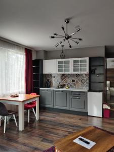 a kitchen with a table and a dining room at The old Bakery Apartments in Plovdiv