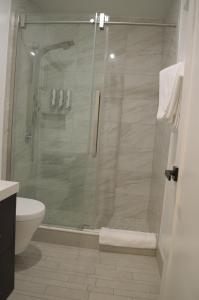 a shower with a glass door in a bathroom at Dimond Abode Vacation Home 2 in Oakland