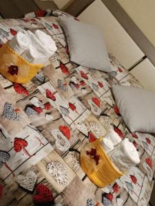 a bed with a christmas quilt on it at B&B Karisma e apartment in LʼAquila