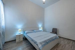 a small bedroom with a bed and a chair at Casa vacanze Petra in Squinzano
