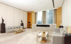 a living room with couches and a tv in a building at Riverdale Residence Xintiandi Shanghai in Shanghai