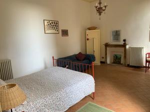 a bedroom with a bed and a fireplace at Case Vacanze La CORTE in Orta San Giulio