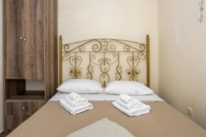 a bed with two towels sitting on top of it at Sun And Stone in Athani