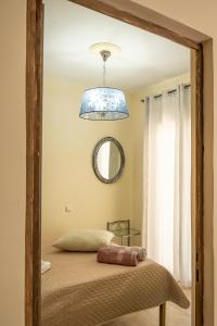 a bedroom with a bed with a blue light at Sun And Stone in Athani