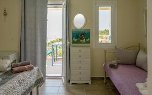 a bedroom with two beds and a dresser and a mirror at Sun And Stone in Athani