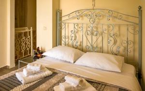 a bed with two towels sitting on top of it at Sun And Stone in Athani