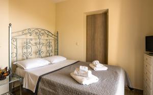 a bedroom with a bed with towels on it at Sun And Stone in Athani