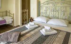 a bedroom with a bed with two towels on it at Sun And Stone in Athani