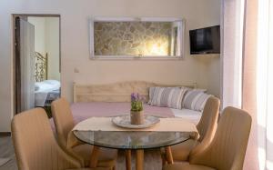 a living room with a table and a bed at Sun And Stone in Athani