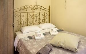 a bedroom with a bed with towels on it at Sun And Stone in Athani