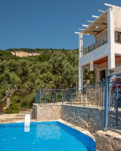 a villa with a swimming pool in front of a house at Sun And Stone in Athani