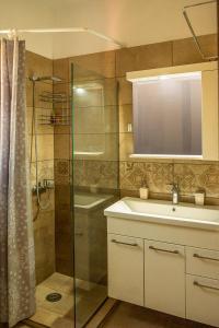 a bathroom with a sink and a shower at Sun And Stone in Athani