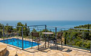 a balcony with a table and chairs next to a pool at Sun And Stone in Athani