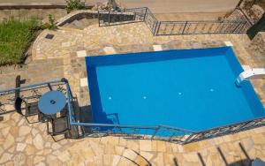 an overhead view of a blue swimming pool at Sun And Stone in Athani