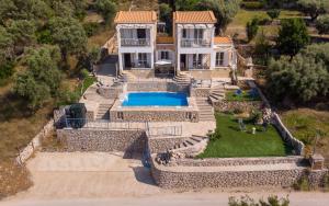 an aerial view of a house with a swimming pool at Sun And Stone in Athani