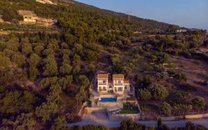 an aerial view of a house on a river at Sun And Stone in Athanion