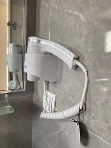 a bathroom with a sink and a water hose at INROY SEA VIEW APARTMENTS in Skala Potamias